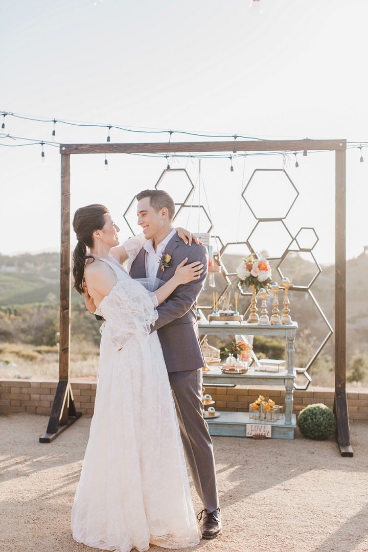 Newlyweds walking toward a mountain view